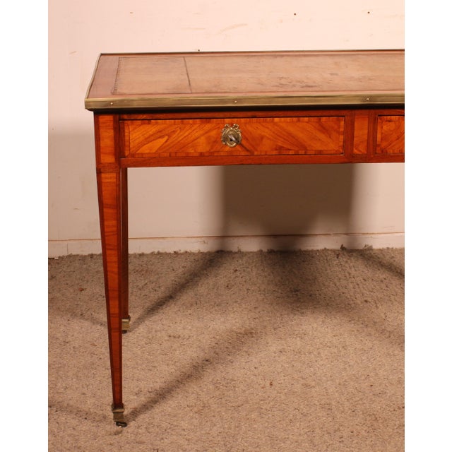 Elegant and rare small Louis XVI period marquetry desk from the 18th century. This beautiful desk features two drawers in...
