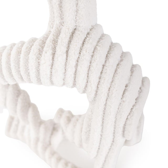 In textured white with ribbed detailing, these sculptures unique shape blend a touch of tranquility to any space....
