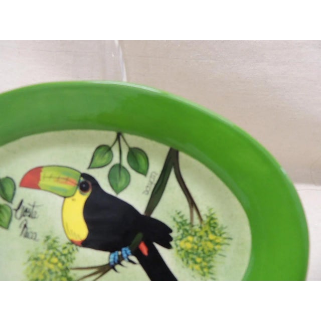 Oval hand painted decorative dish depicting a Tucan 20th century, Costa Rica Signed by artist and titled: El Paisaje Safe...