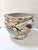 This large vintage Chinese porcelain fishbowl planter features vibrant famille rose style decoration with floral panels,...