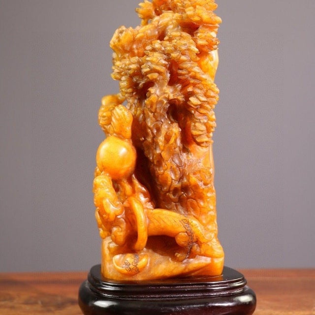 This is a highly detailed and intricately carved stone sculpture depicting a mythical dragon amidst a stylized cloud or...