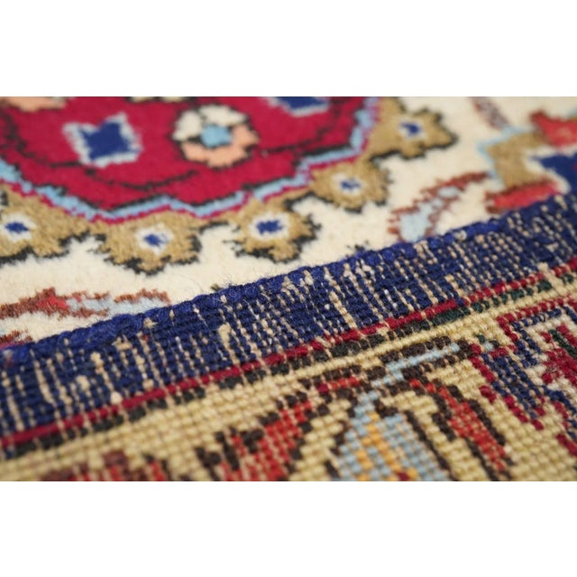 This is a compact, finely woven, version of the famous "Ardebil Carpet". Here a round, flame-edged ecru medallion sports...