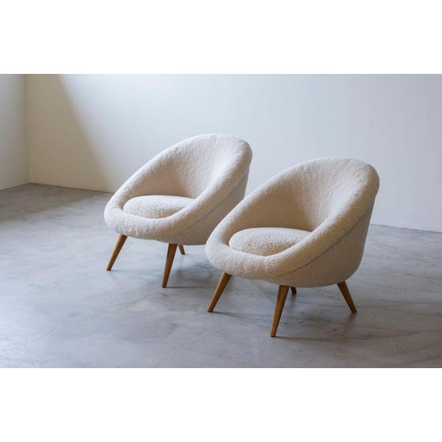 Lounge chairs in the style of Jean Royeres famous "Oeuf" model. Very nice shape and quality. Reupholstered with plush...