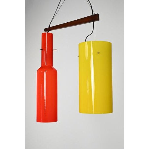Italian 60s hanging lamp with yellow and red glass, wood and brass details. Typical 60’s modernism. A beautiful and...