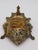 Elevate your workspace with this handsome vintage solid brass inkwell stand, featuring striking Baroque and Rococo-style...