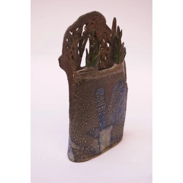 1970s "botanical" stoneware vase representative of a planter with a brown mottled surface with pops of green, blue, white...