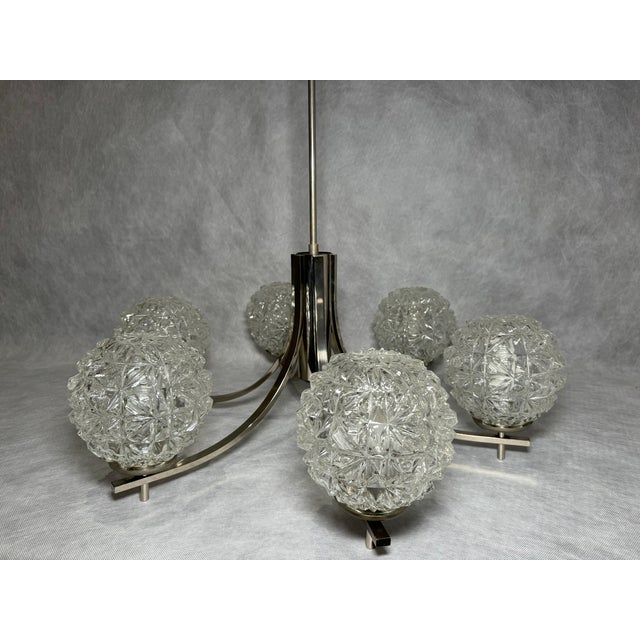 Stylish chandelier by Fischer Leuchten, produced in Germany in the 1970s–1980s. The chrome-plated metal frame is paired...