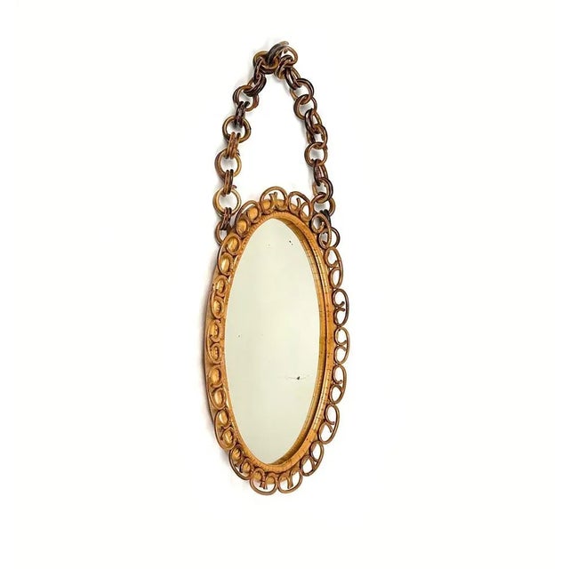 Midcentury Beautiful oval wall mirror in bamboo and rattan with chain. Made in Italy in the 1960s. Bamboo / rattan has...