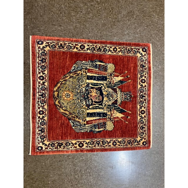 Vintage Hand-knotted Persian Kashkoli wool rug featuring a red field with a central figural medallion depicting a stylized...