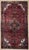 Antique hand-knotted rug from the Nahavand region of western Iran, featuring a rich, abrashed burgundy field with a large,...