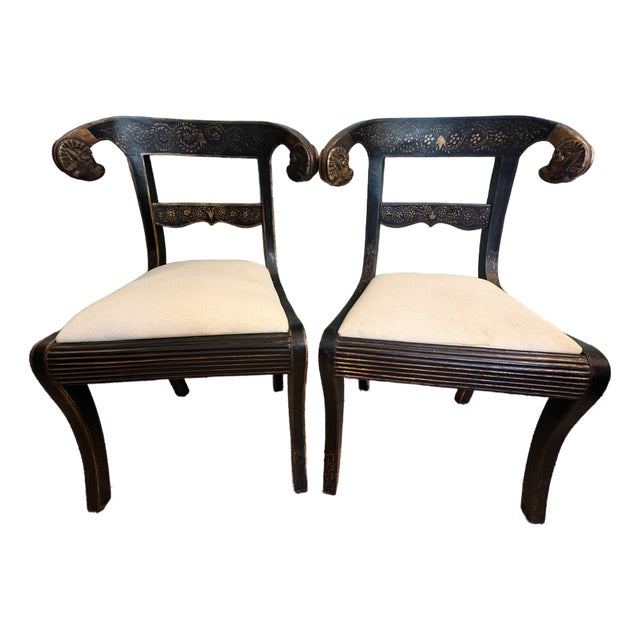 Late 20th Century Pair of Anglo-Indian Style Ebonized & Gilt Ram's Head Klismos Chairs With Floral Penwork For Sale