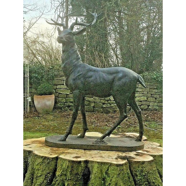 An impressive life-size cast iron stag sculpture, beautifully modelled with magnificent branching antlers and a proud,...