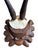 Goat hor trophy on a wood plaque carved with pinecones and pine sprigs.