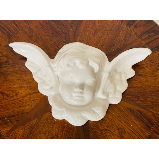 Regency style glazed porcelain cherub with wings wall sculpture.