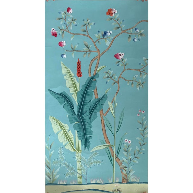 Exquisitely hand-painted chinoiserie mural set with calming teal background, showcasing lush tropical banana leaves, palm...