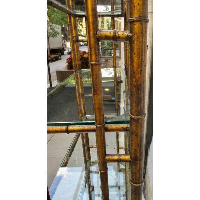 Chinese Chippendale Pagoda-Style Faux-Bamboo Etagere. Patina of bronze gold with bamboo accents. The construction is iron...