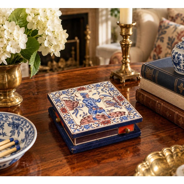A wonderfully unusual decorative object, this vintage matchbox holder is constructed around a Delft-style ceramic tile...