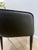 A modern barrelback dining armchair from our Ikon collection, upholstered in Abbington black fabric and contrasting napa...
