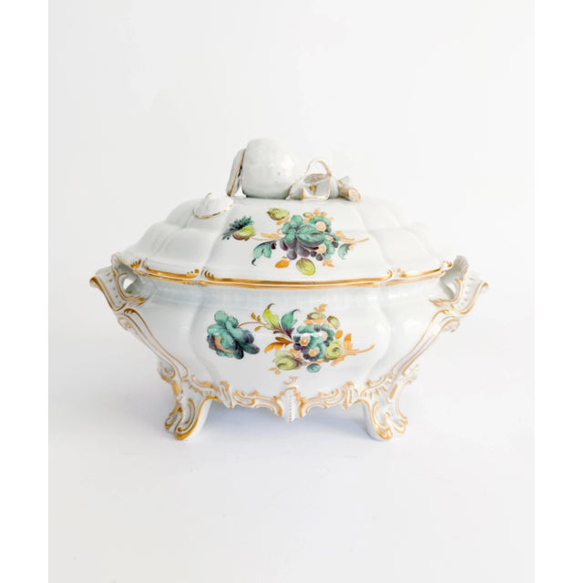 This spectacular Roco Revival hand-painted porcelain tureen by Nymphenburg features a gilded rim, a blue and green floral...