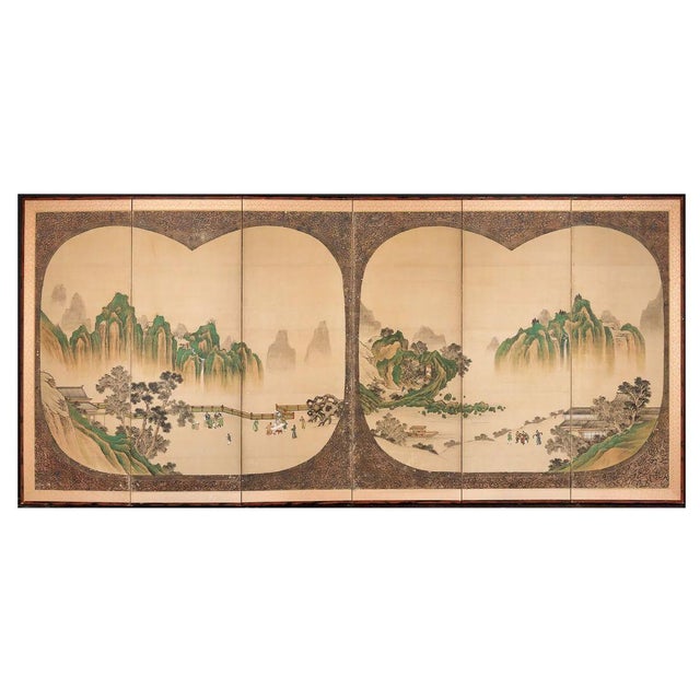A Japanese six panel byobu folding screen featuring a finely detailed mountainous landscape with traditional architecture,...