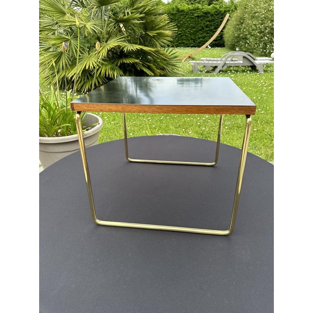 Pierre guariche, rare so-called “flying” table luxury version, tubular base in solid brass, black formica top, its...