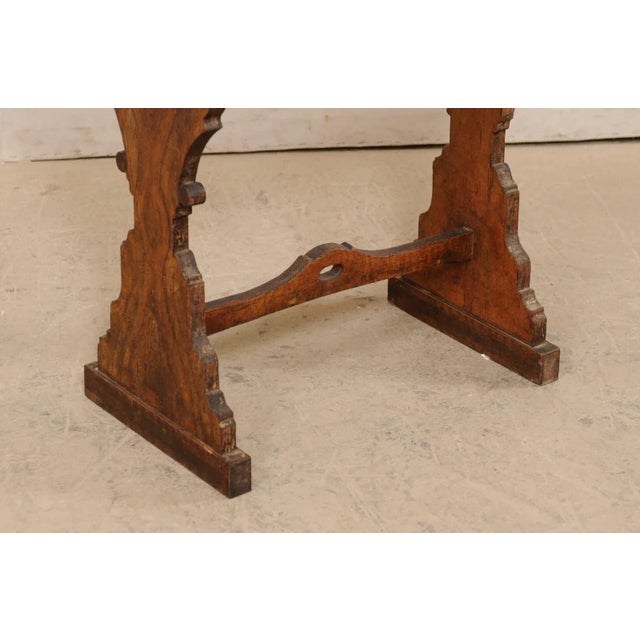 An Italian small sized table, or writing desk, from the 19th century. This antique table from Italy features a...