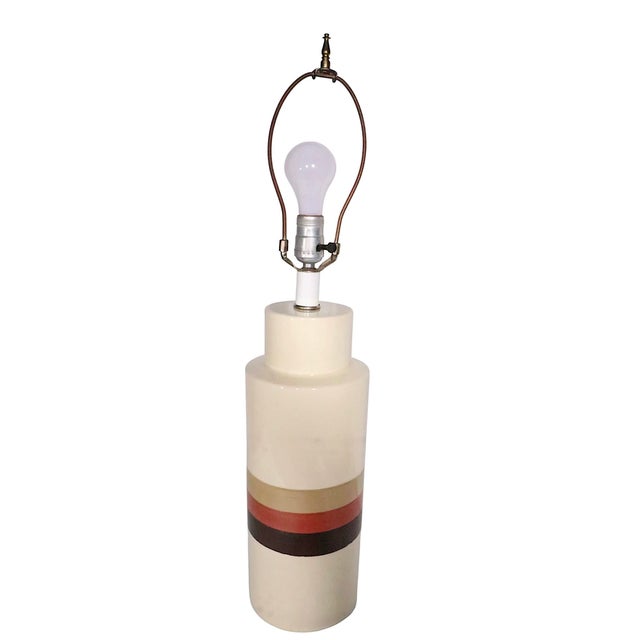 Mod style ceramic table lamp by Philmar - Sandel. The lamp features a cream color body with three decorative colored...