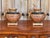 A pair of Neoclassical painted and gilt flatback urn ornaments in the Egyptian taste — each half-round bowl with black...