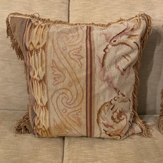 Pretty pair of antique neoclassical striped needlepoint tapestry pillows with fringe. Floral and acanthus scroll design in...