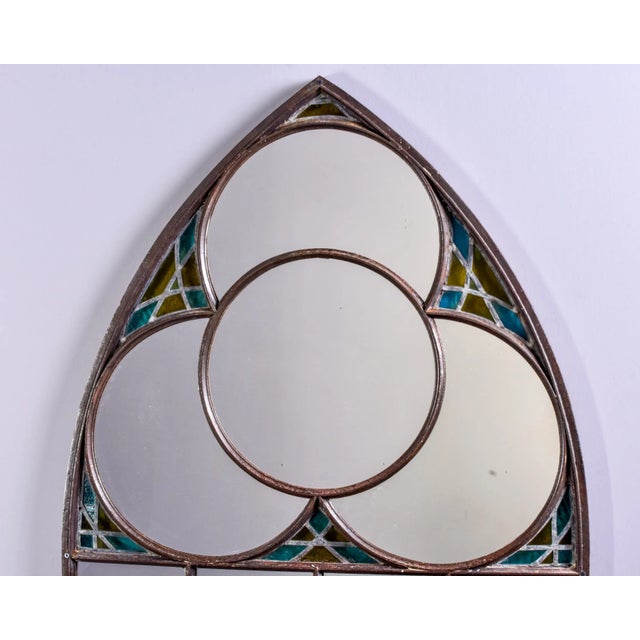 Found in France, this circa 1890s Century iron framed church window with stained glass has been refitted with a mirror....