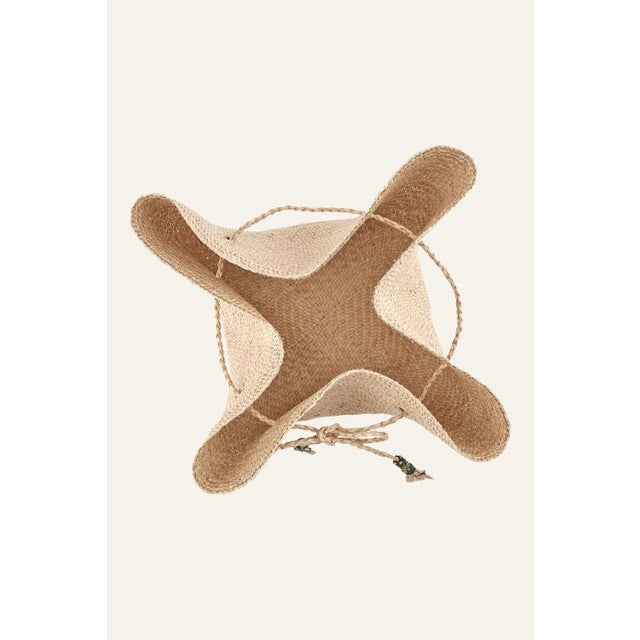 Johanna Ortiz brings back her beloved bread baskets, crafted from iraca fiber and accented with colorful tassels....