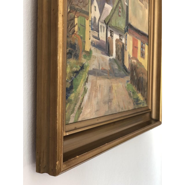 A vintage original oil painting of a Scandinavian village scene, dating from 1950. The painting shows colourful cottages...