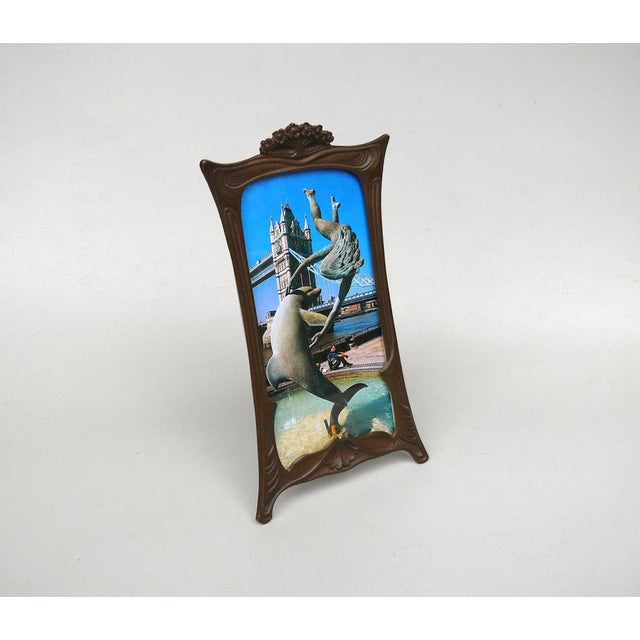 A delicate yet elegant picture frame from the Art Nouveau period, made in France with floral elements. It is made of dark...