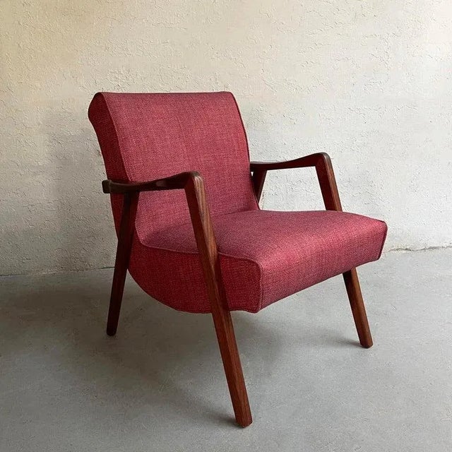 Scandinavian modern armchair features a sculptural walnut frame with scoop seat newly upholstered in raspberry tweed.