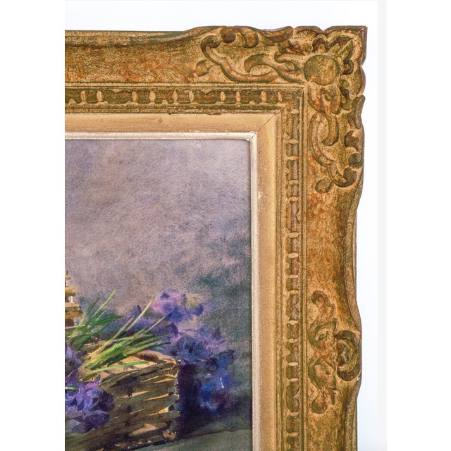 Framed Watercolor | Early 1900s | Artist Unknown A delicate watercolor still life featuring a basket of purple violets,...