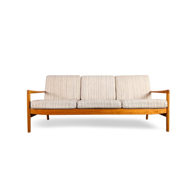 Beautiful vintage sofa from the 1960s for sale. The three-seater features a refinished wooden frame made of high-quality,...