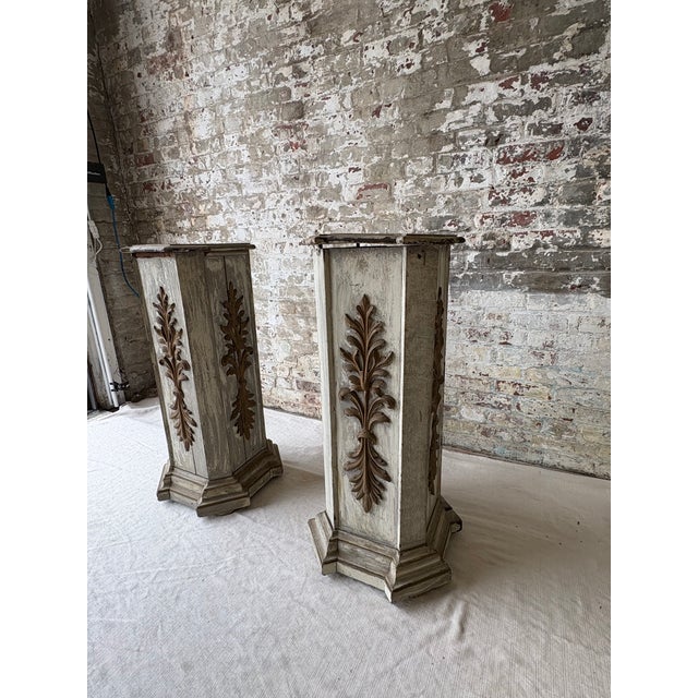 Impressive pair of monumental vintage wood pedestals featuring an octagonal column form, stepped plinth bases, and richly...