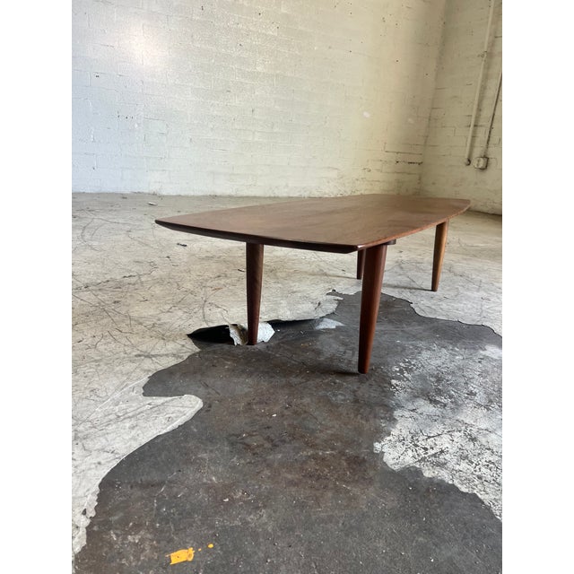 Newly refinished mid century modern walnut coffee table, featuring beautiful wood grain with soft edges and tapered legs....