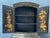 An impressive Black Lacquer Chinoiserie Cabinet, richly decorated with intricate gilt detailing and traditional Asian...