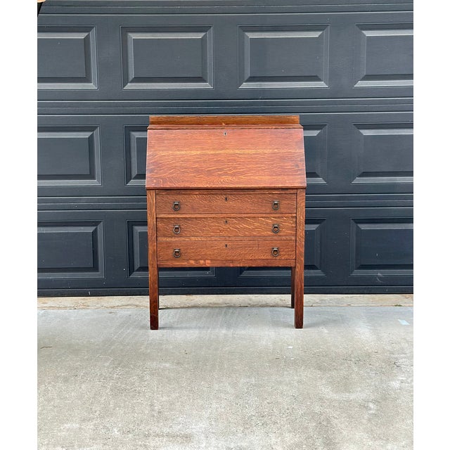 This striking antique solid wood secretary desk by Rockford Chair & Furniture Co. of Rockford, Illinois is a beautiful...