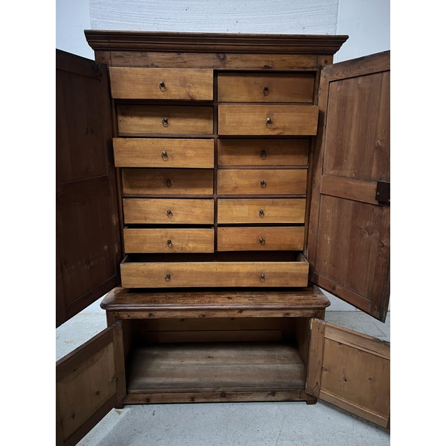 Two-part solid fir sideboard office/administrative cabinet the upper section has thirteen drawers for storage the lower...