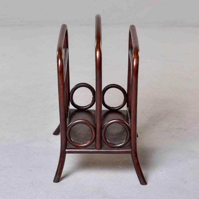 A charming bentwood magazine rack by Thonet, Vienna, circa 1900–1910. Steam-bent beechwood in original dark walnut stain...