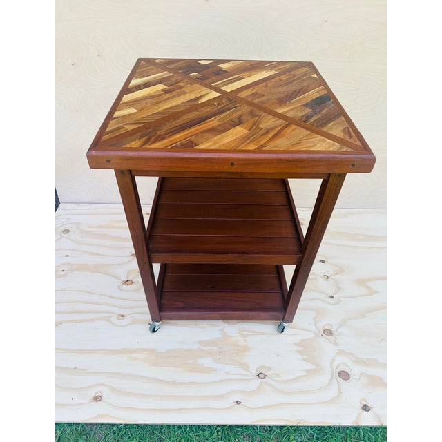 This handmade rolling cart is a striking and skillfully crafted piece, showcasing the natural beauty and contrast of black...