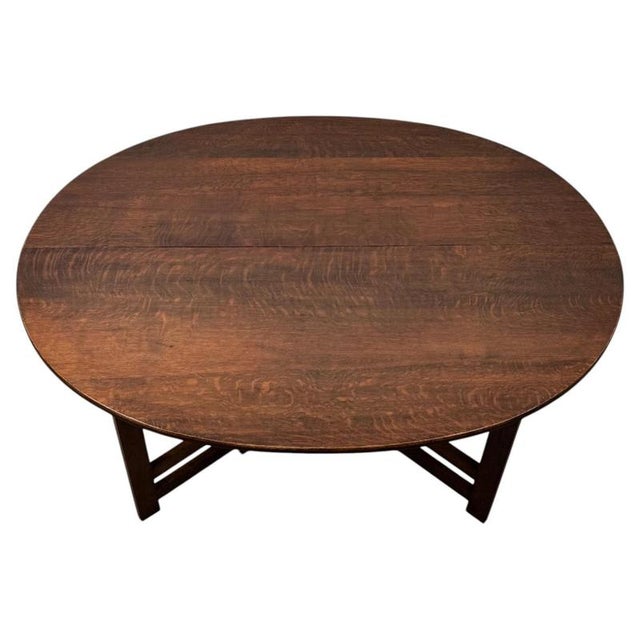An unusual and beautifully crafted early 20th-century Arts and Crafts gateleg side table, constructed in richly coloured...