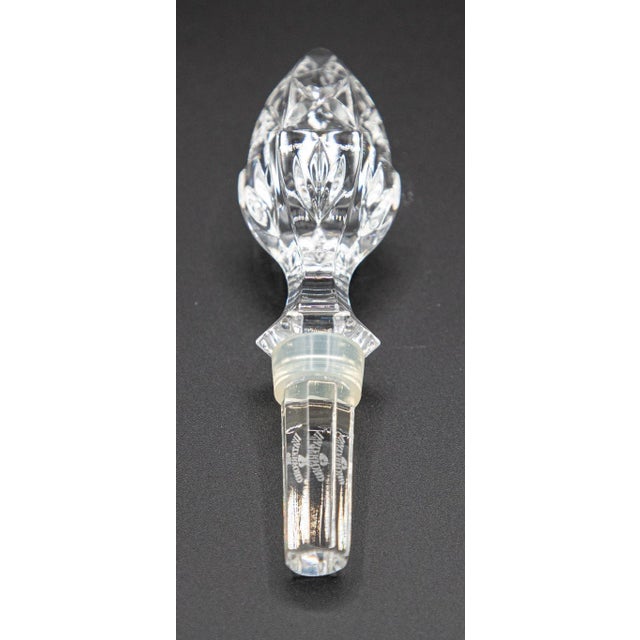 Pair of Waterford crystal bottle stoppers featuring two distinct finial styles. One is sculpted as a horse head and the...