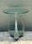 This striking side table features a captivating figural base composed of three expertly cast elephants in a tripod...