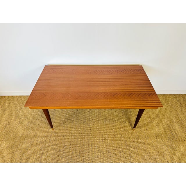 This elegant vintage Art Deco table from the 1950s features a design typical of French modernist furniture of the period....