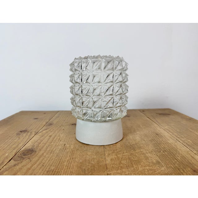 Vintage industrial ceiling or wall light made in former Czechoslivakia during the 1970s. It features a white porcelain...