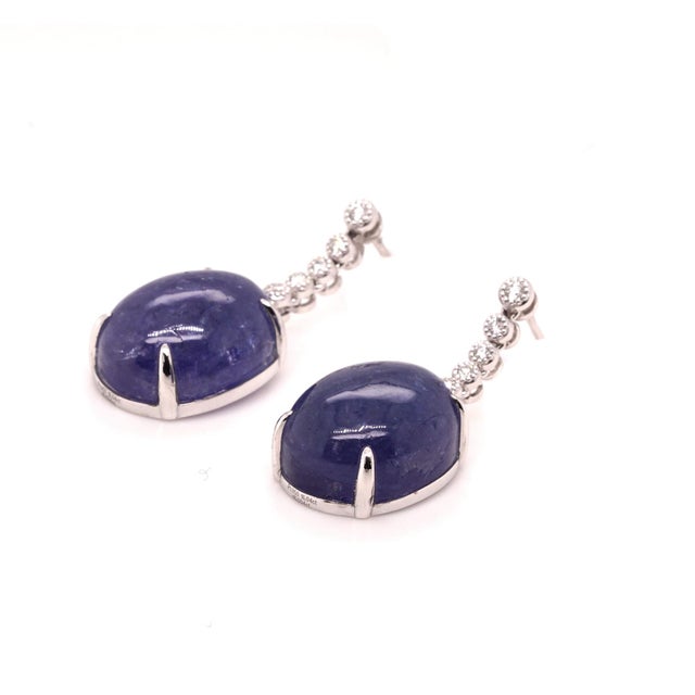 Elevate any jewellery collection with these striking platinum tanzanite and diamond drop earrings. Showcasing a...