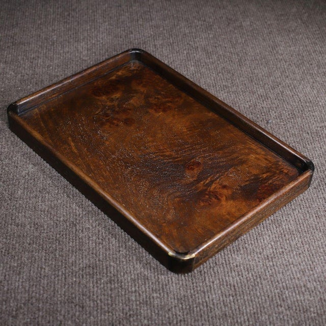 A beautifully crafted Chinese rectangular tray, likely made of Huali (rosewood). The piece features a flat center...